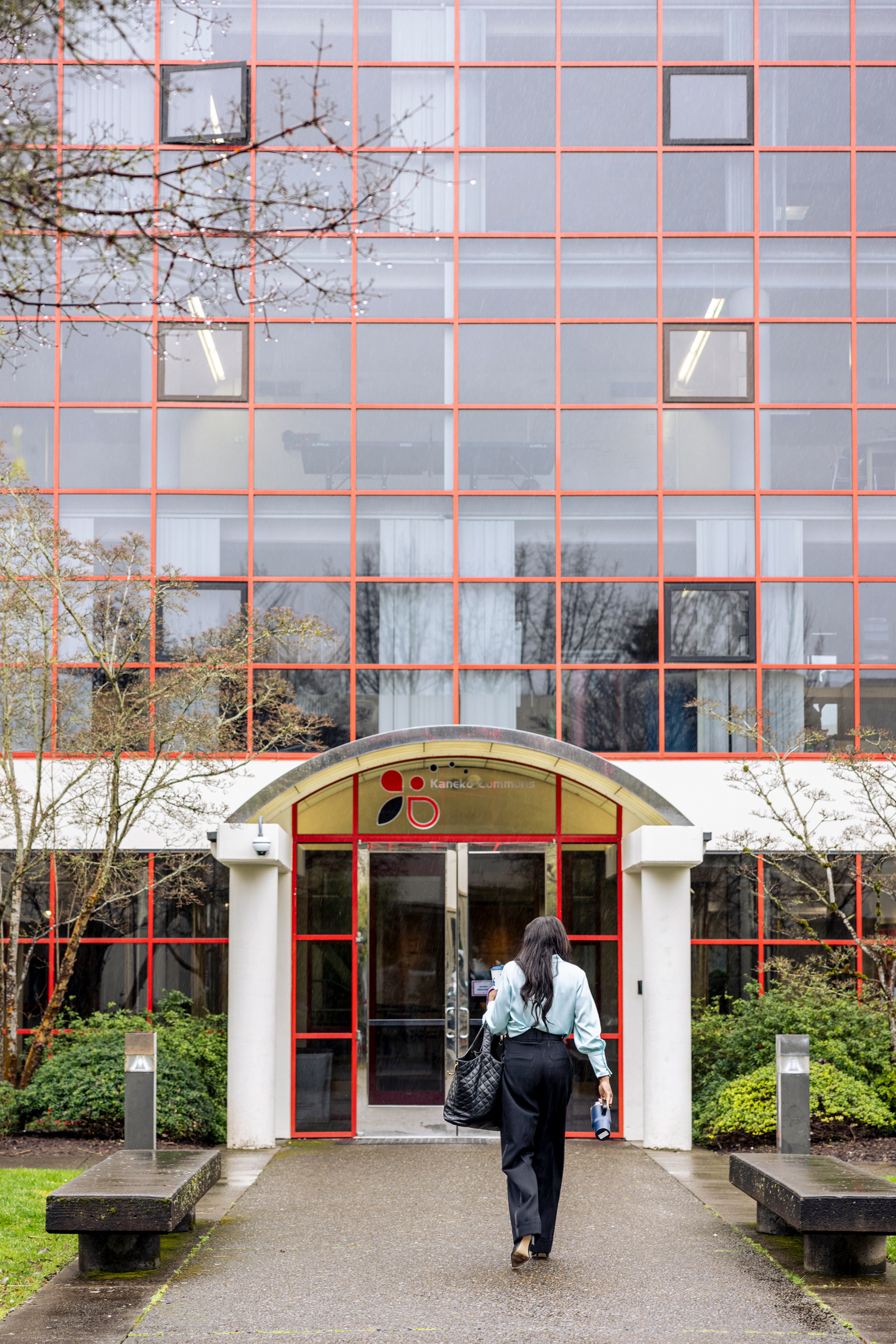 Photograph of Jasmine Ames walking into the campus building